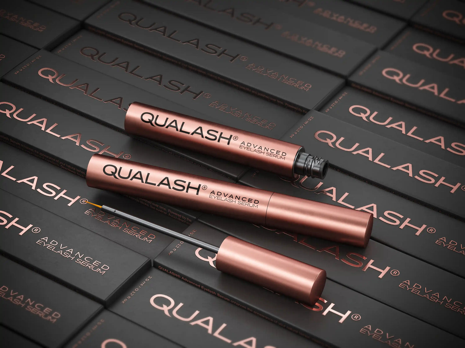 Flatlay of Qualash Advanced Eyelash Serum on branded packaging